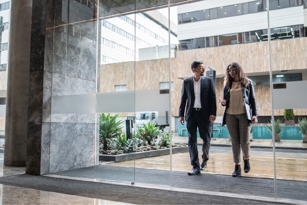 Two professionals walking through lobby